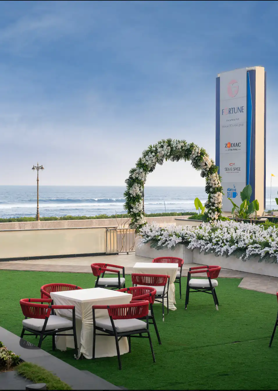 Beachfront event lawn with floral arch and sea view at Fortune Beachfront Puri