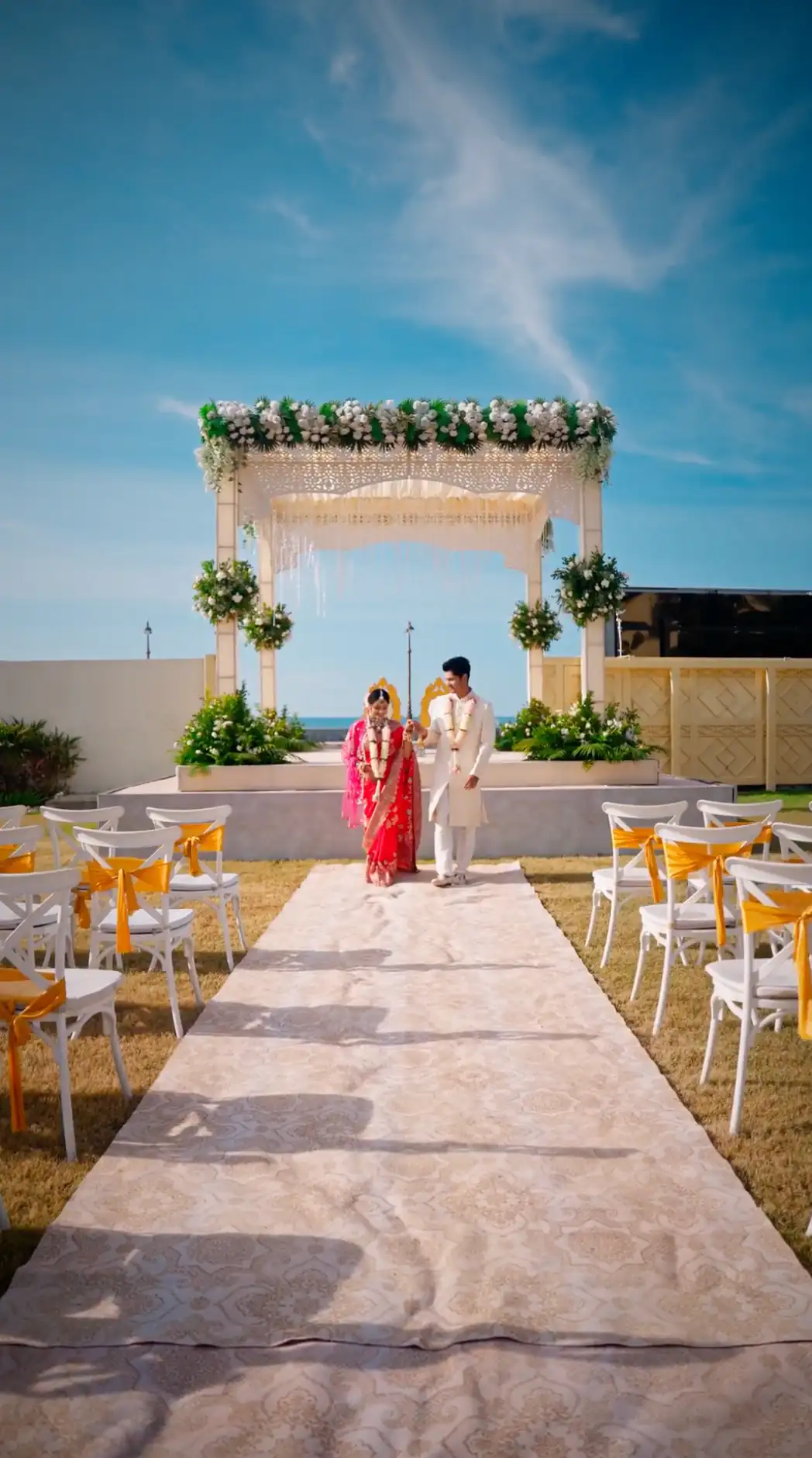 Newly married couple walking through a beachfront wedding ceremony at Fortune Beachfront Puri