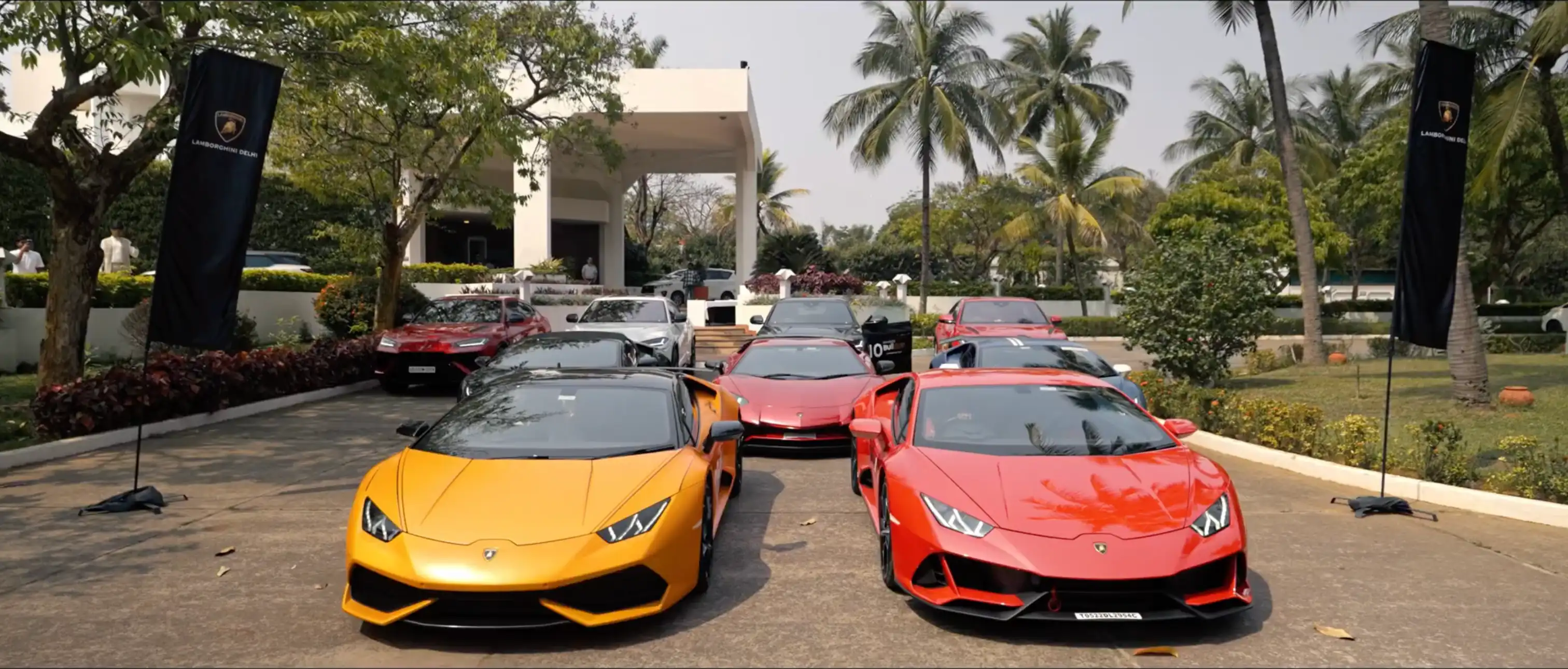 Yellow and red Lamborghinis leading a lineup of cars at the 2024 India Bull Run