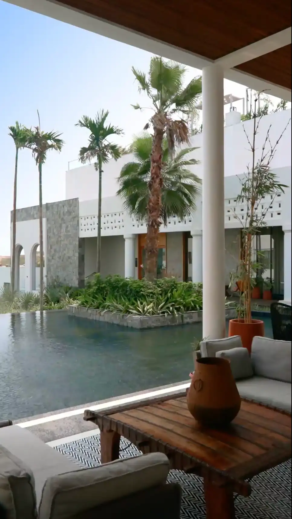Poolside courtyard and palm trees at Pramod Lands End in Gopalpur