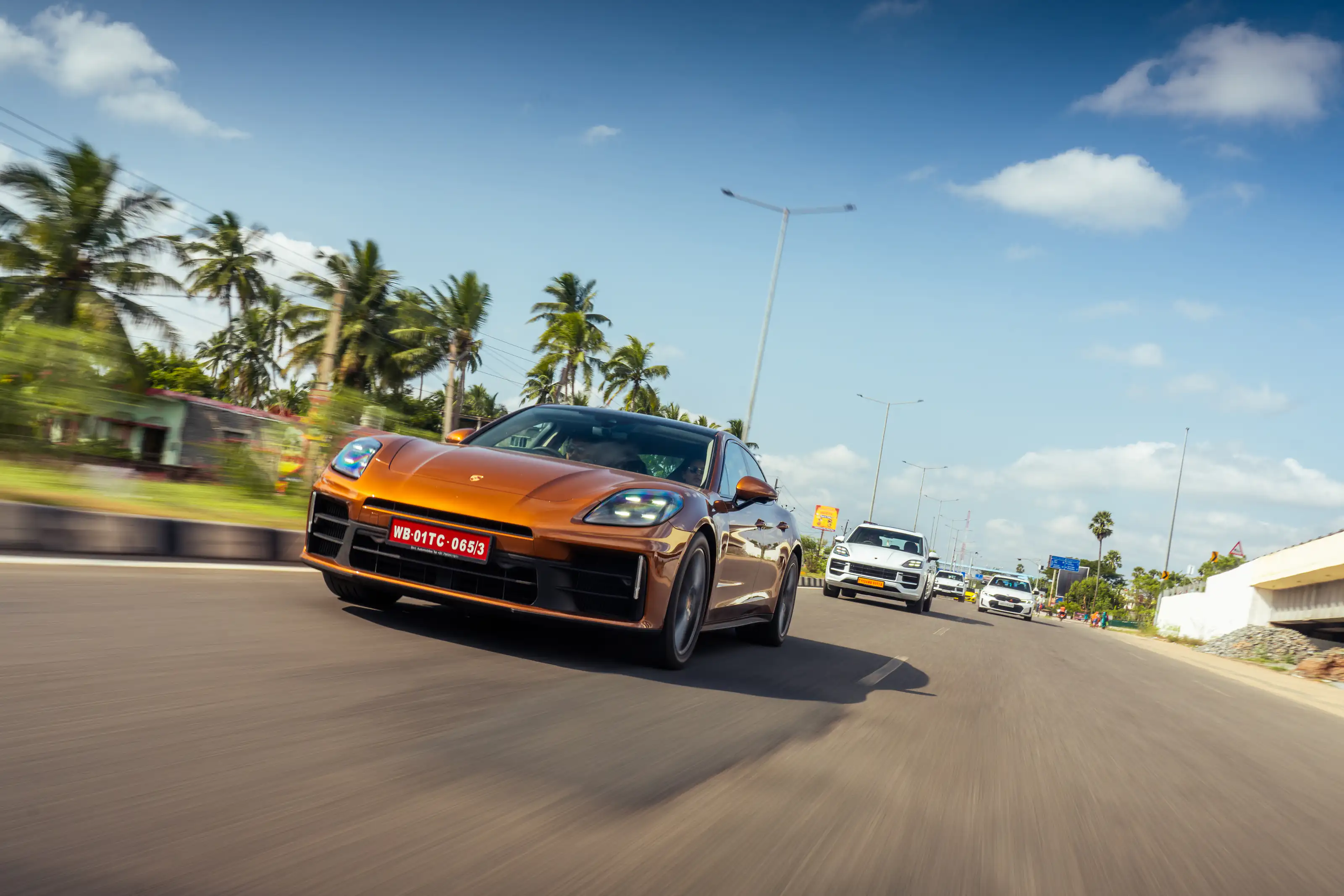 Copper Porsche photographed low and wide while driving
