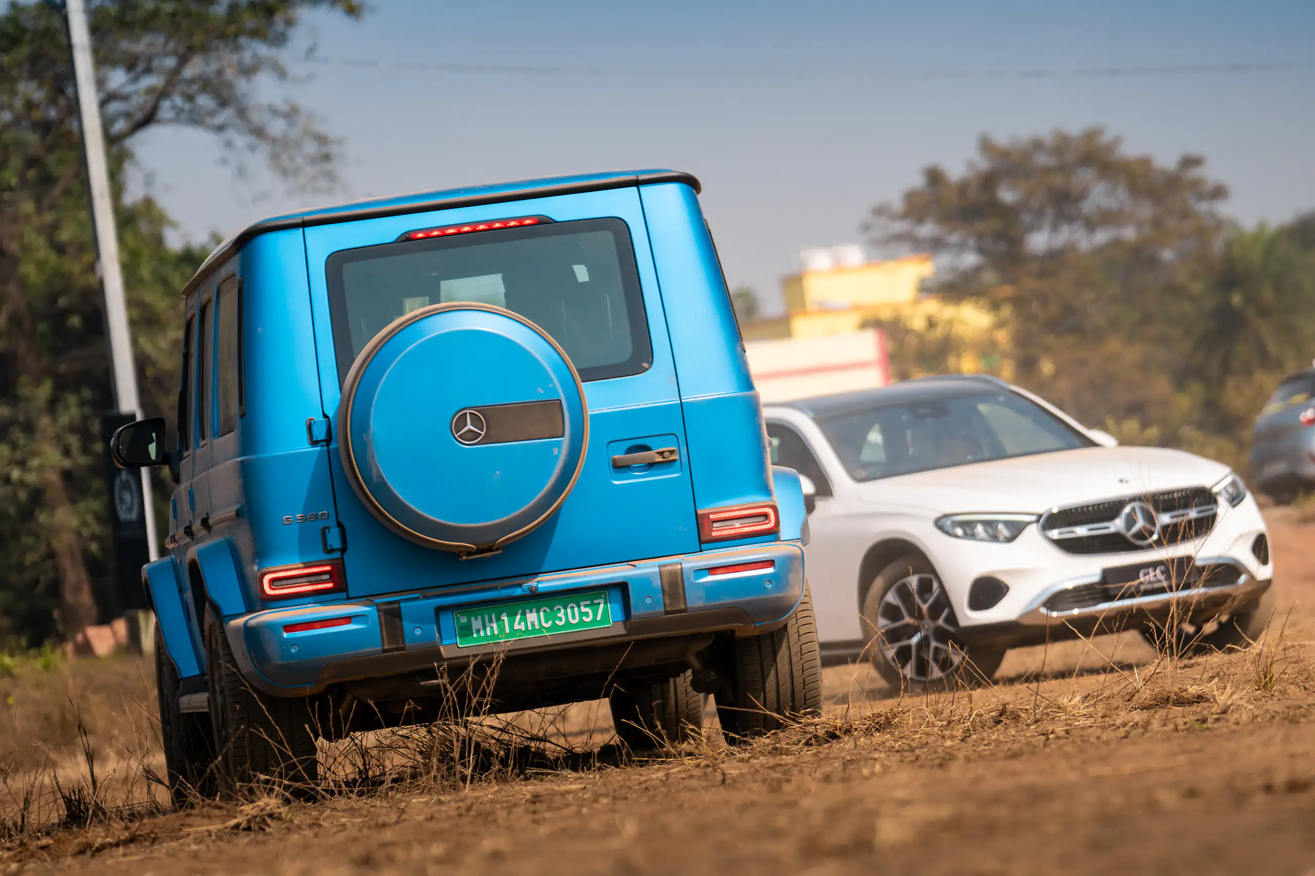 Blue and white Mercedes-Benz SUVs parked together after an off-road drive