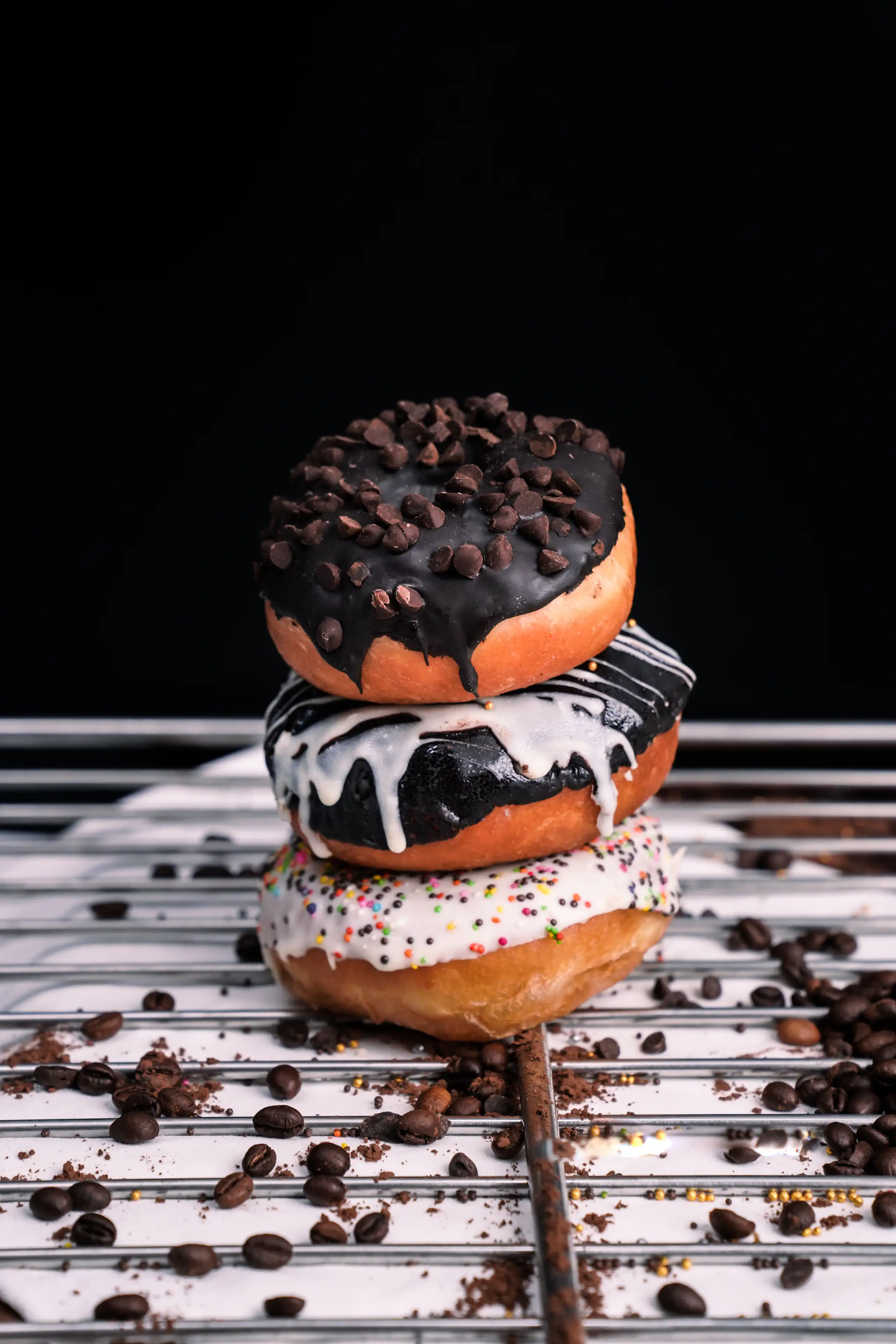 Chocolate-glazed doughnut isolated against a black background