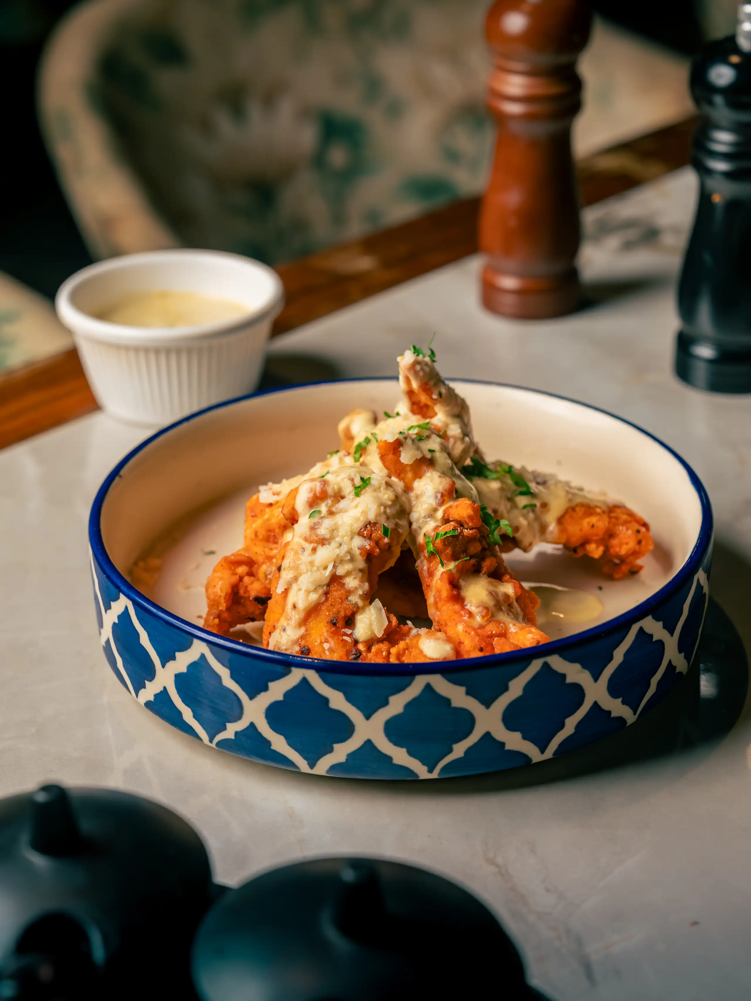 Creamy plated dish served in a blue patterned bowl