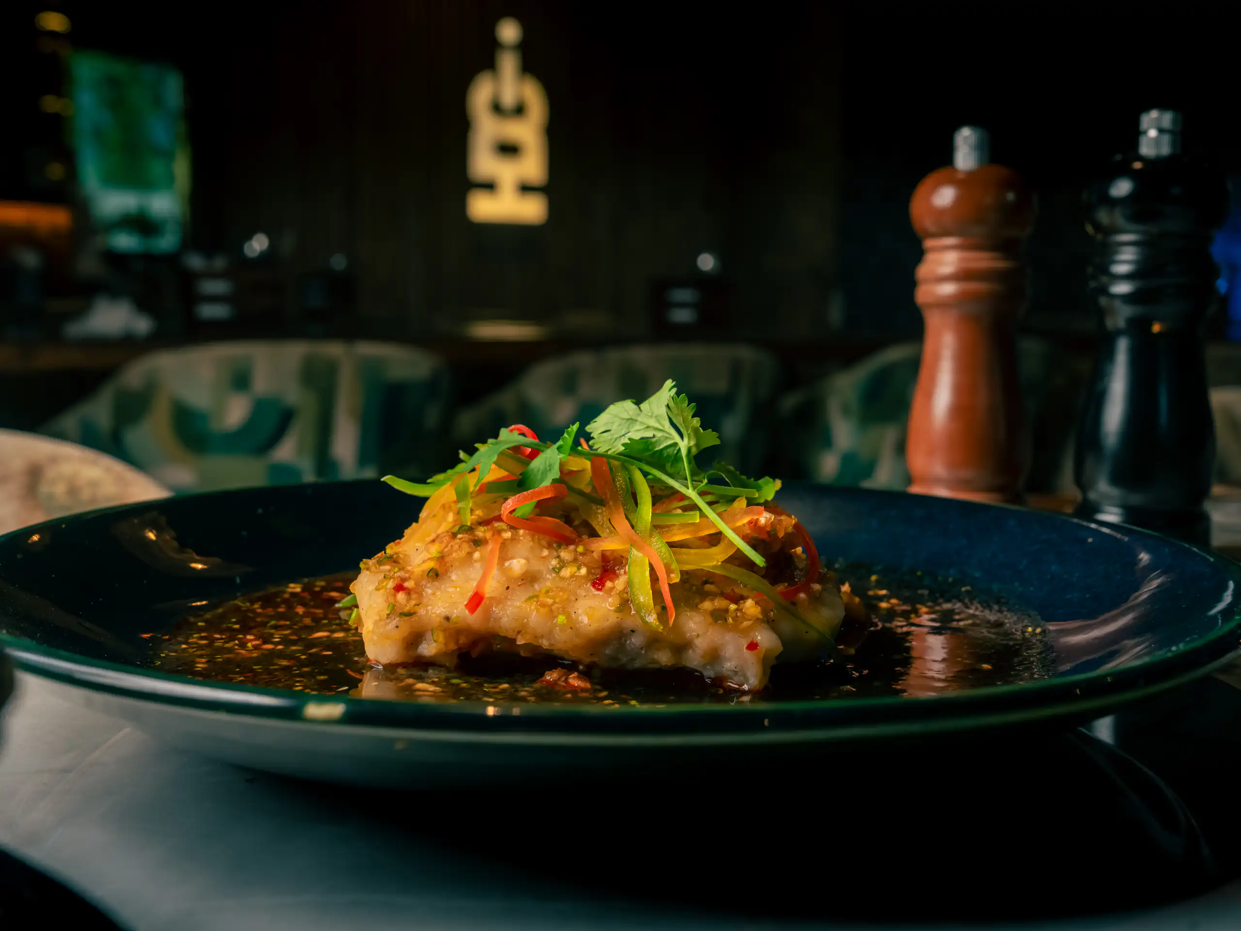 Biryani served in a ceramic pot with herbs and fried onions