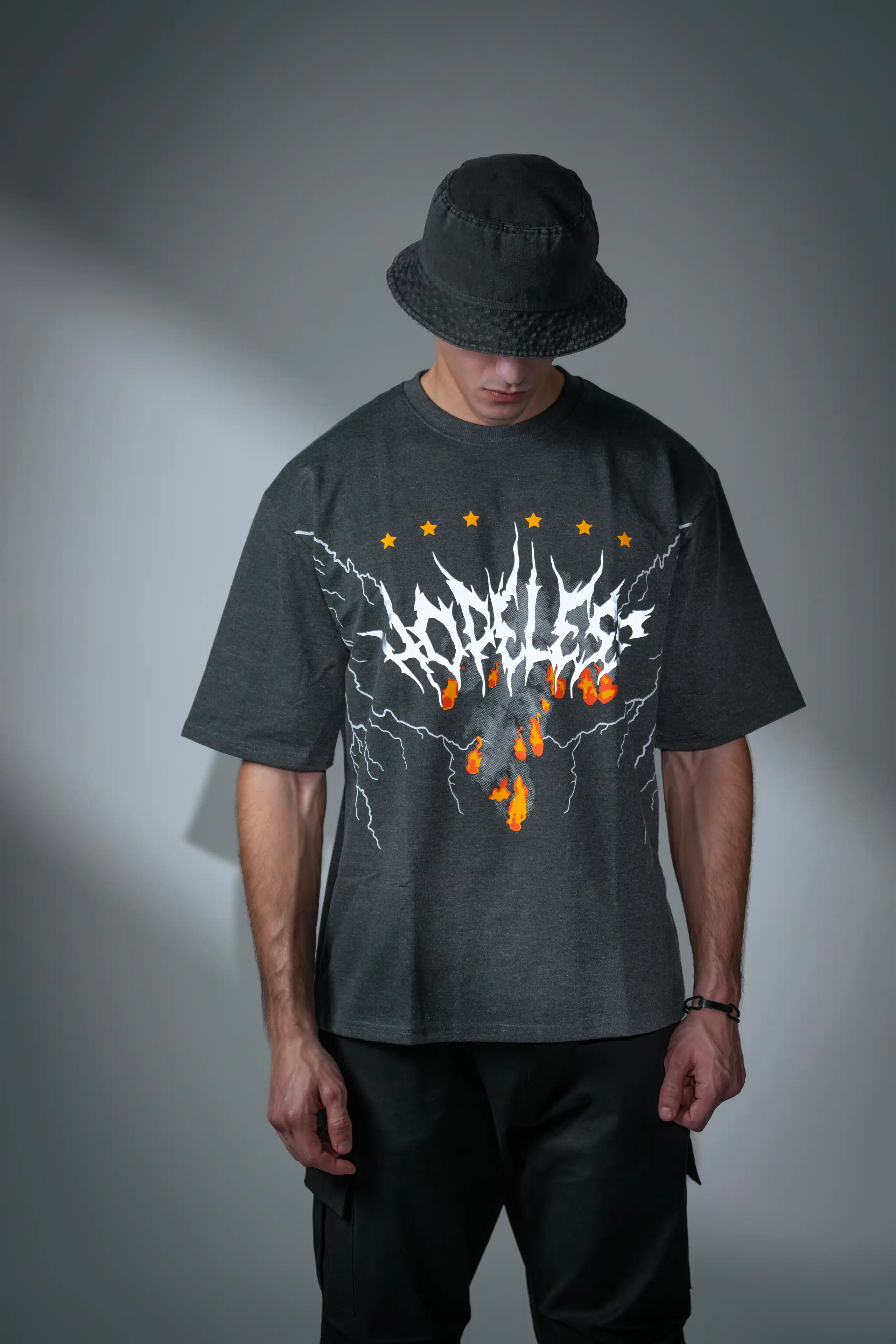 Streetwear model in a black bucket hat and oversized graphic T-shirt