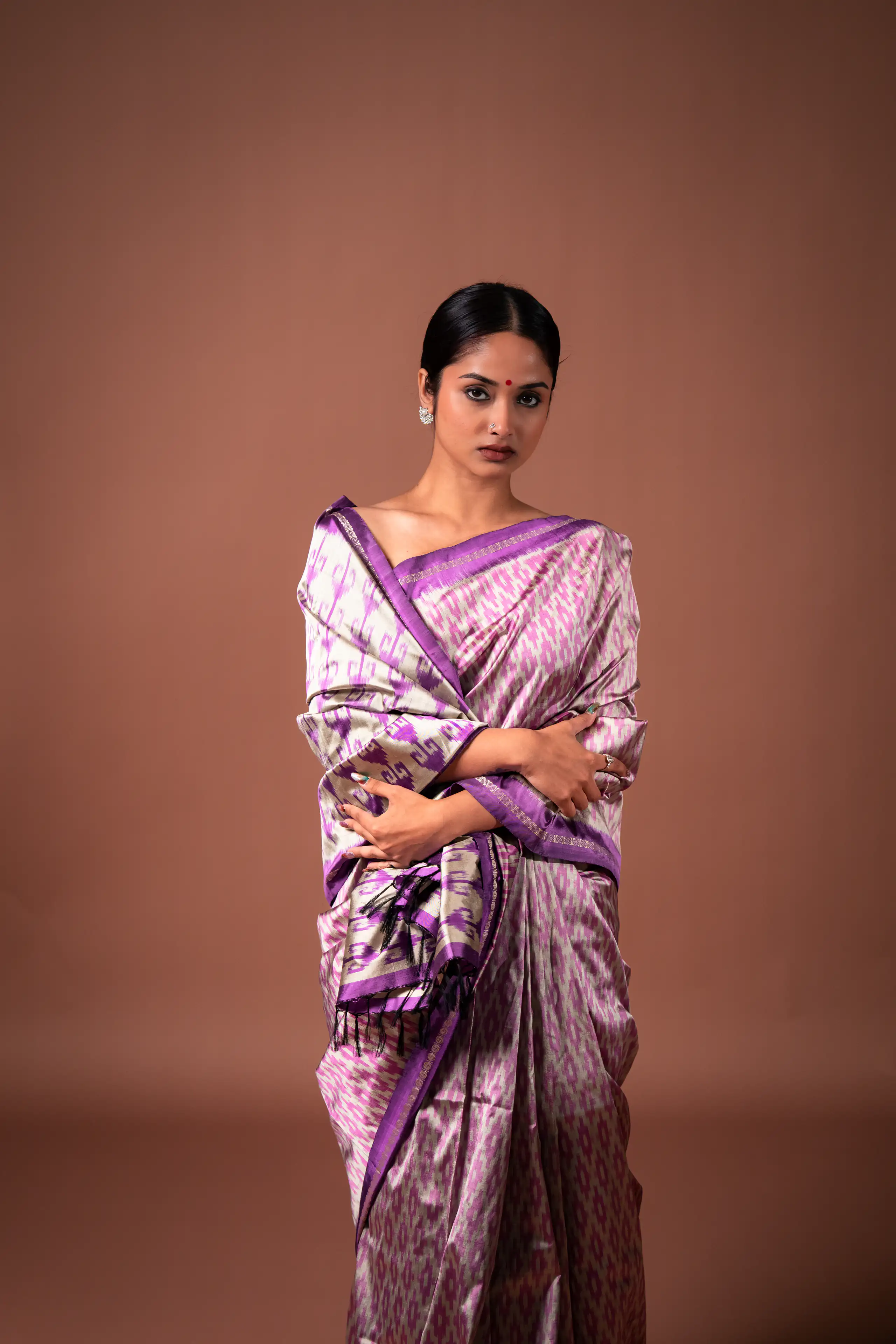 Close portrait of a woman wearing a lavender patterned sari