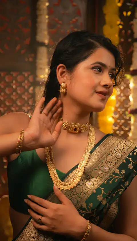 Close portrait of a woman in a green and gold sari
