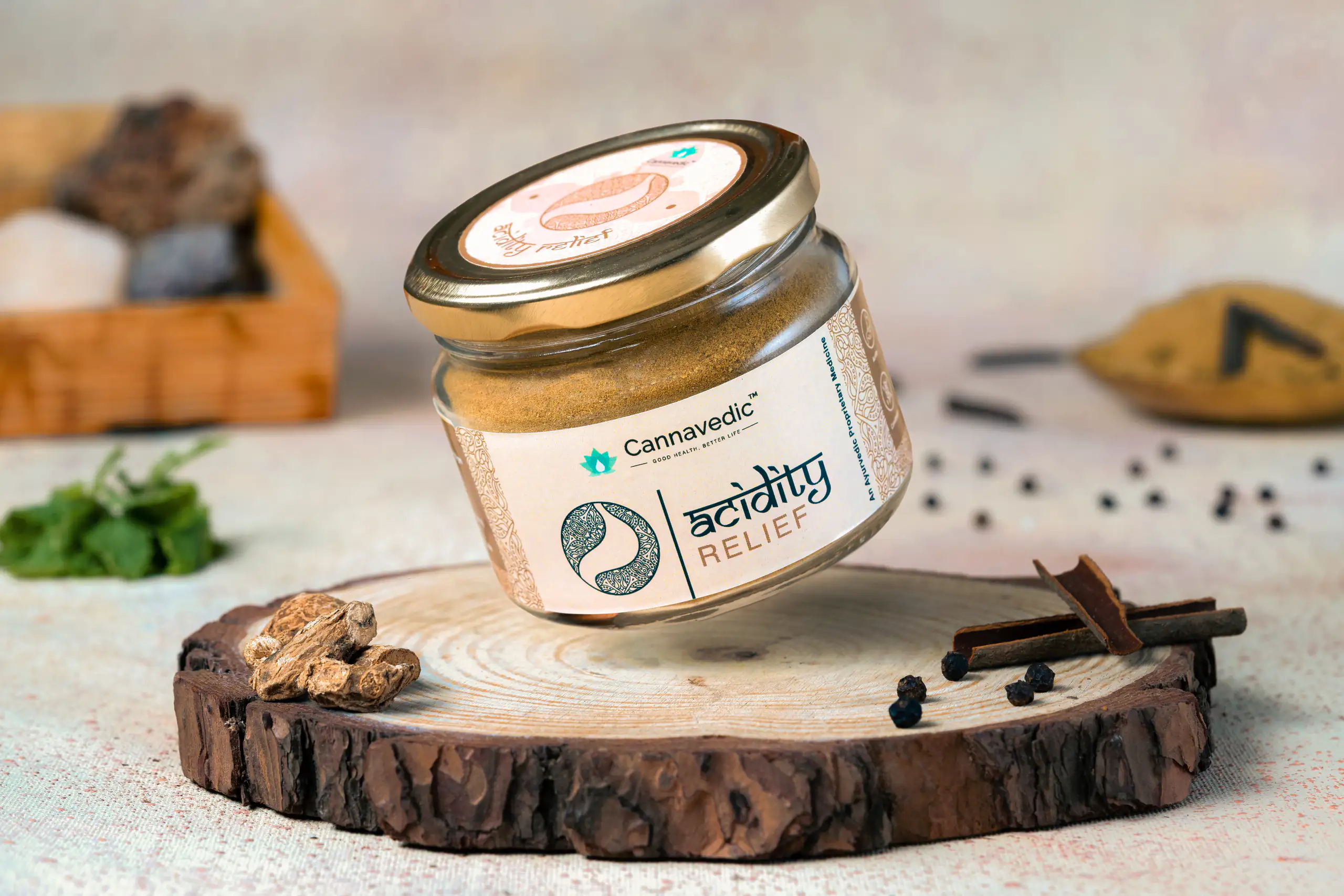 Ayurvedic product jar arranged with herbs and spices on a wooden slab