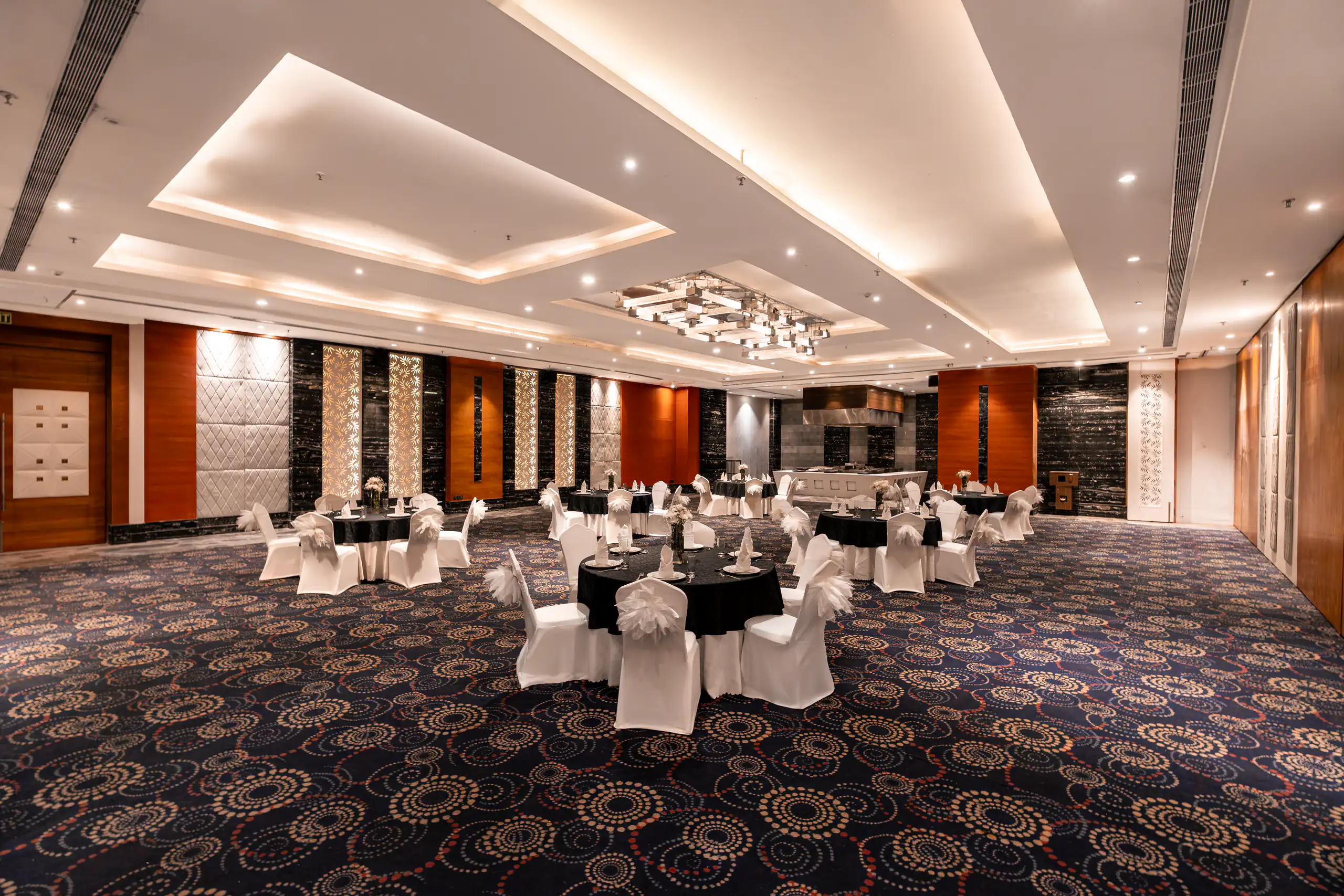 Wide symmetrical view of a prepared hotel banquet hall